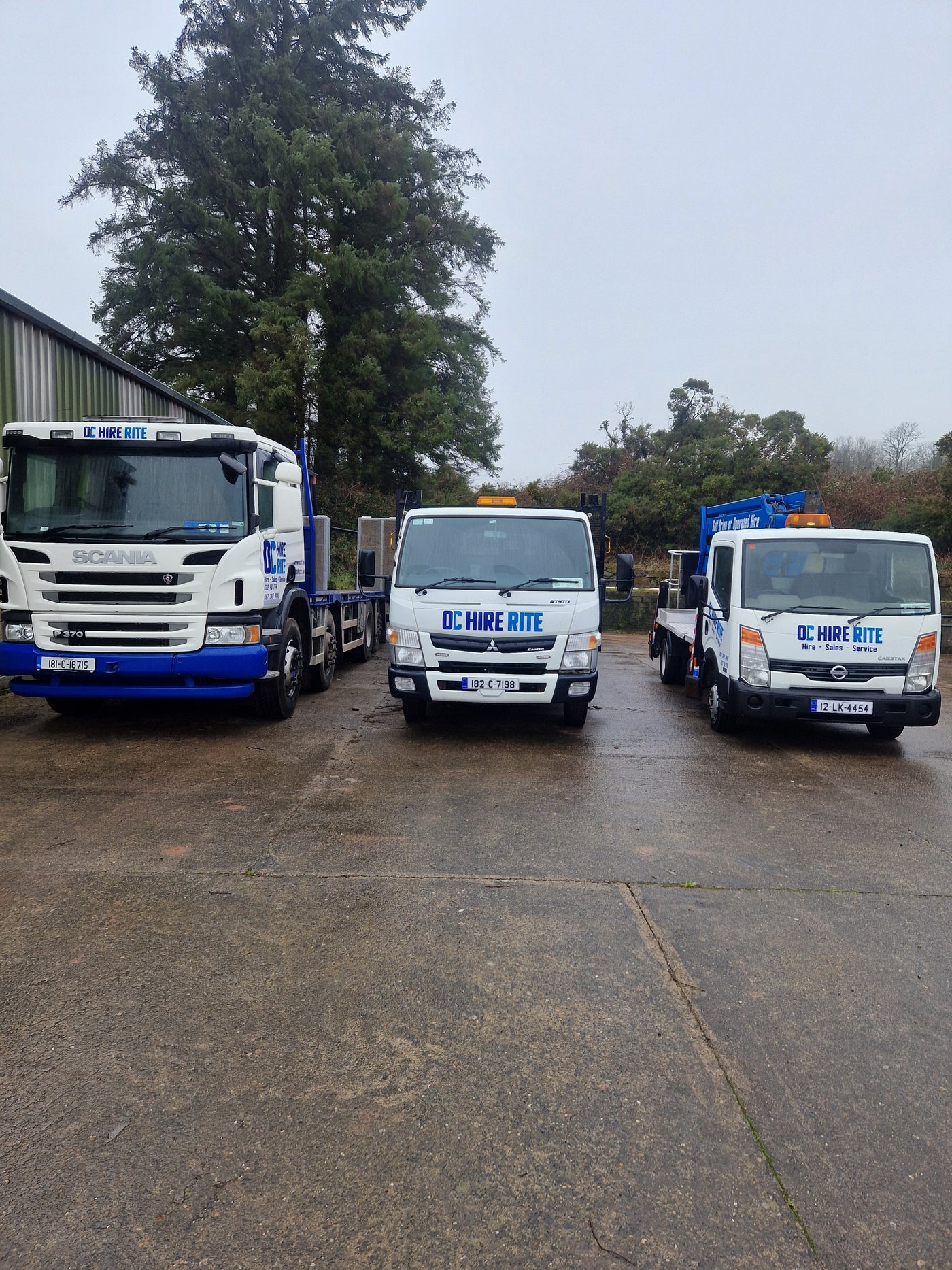 Three trucks with visible branding on a street